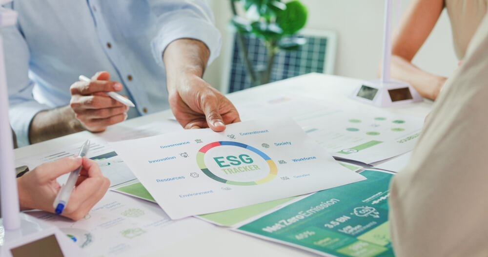Team around the table working with ESG principles.