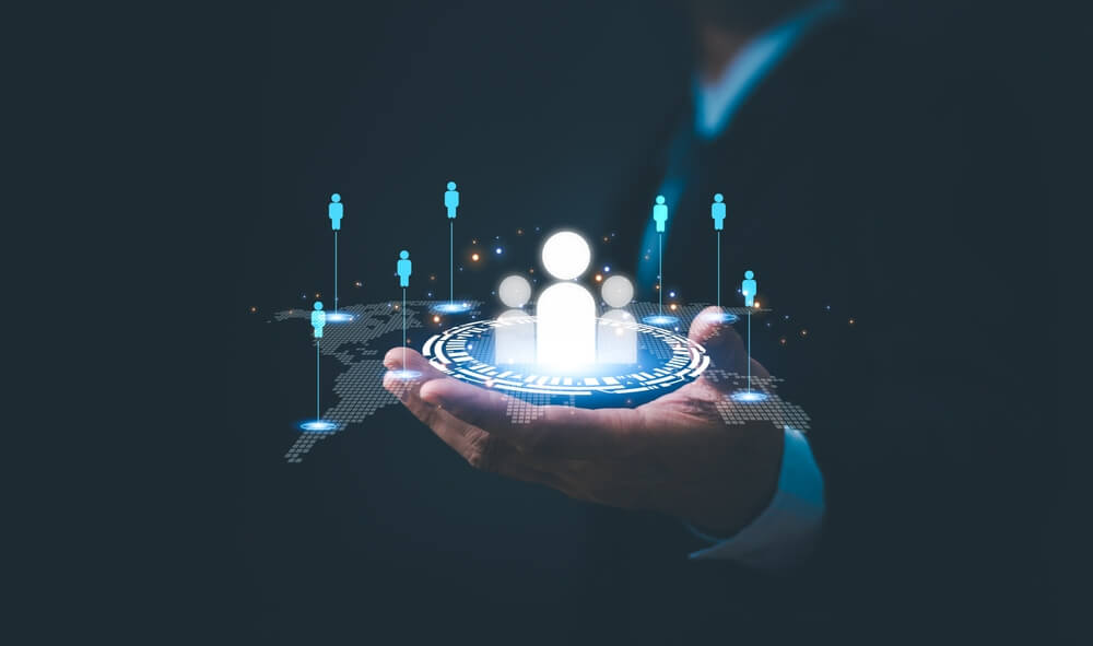 Concept of acquisitions, man holds candle lights in his hands in the dark.