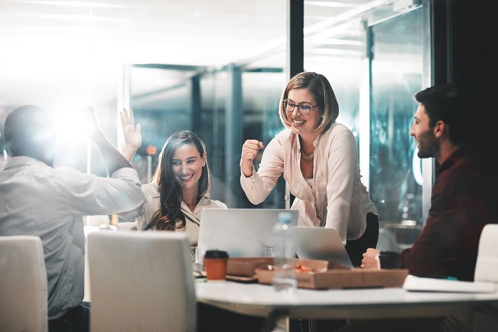Business people work together to navigate their companies through an acquisition.