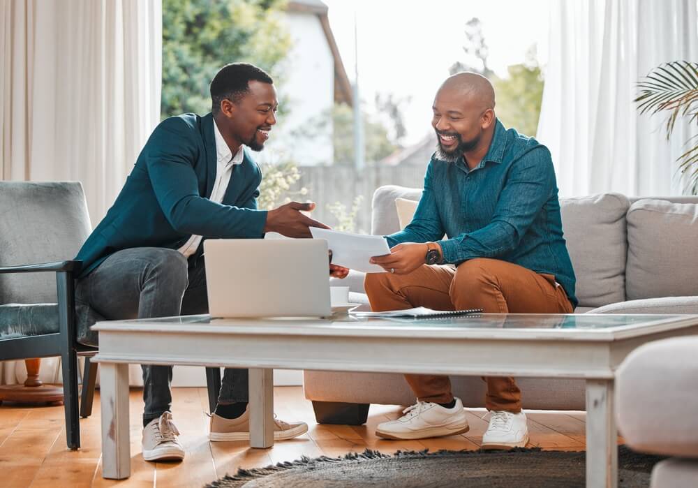 Broker, contract and man in a house with a client for meeting or consultation for customer-centric advice. Financial advisor with a male person to explain investment, savings plan or budget and insurance on paper.