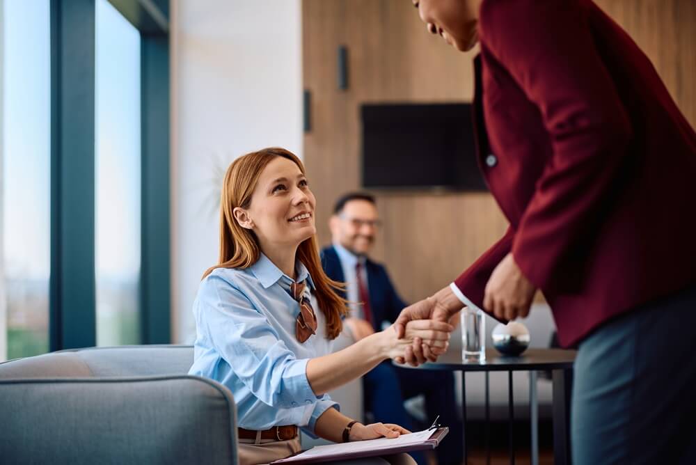Insurance agent shaking hands with a client during a consultation, highlighting the relationship-driven nature of the insurance industry and the value of personalized service.